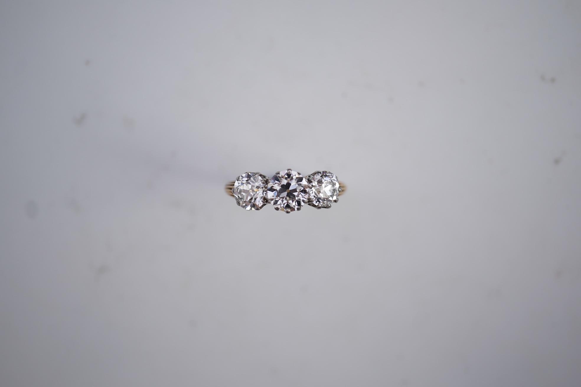 An attractive three-stone diamond ring, early 20th century